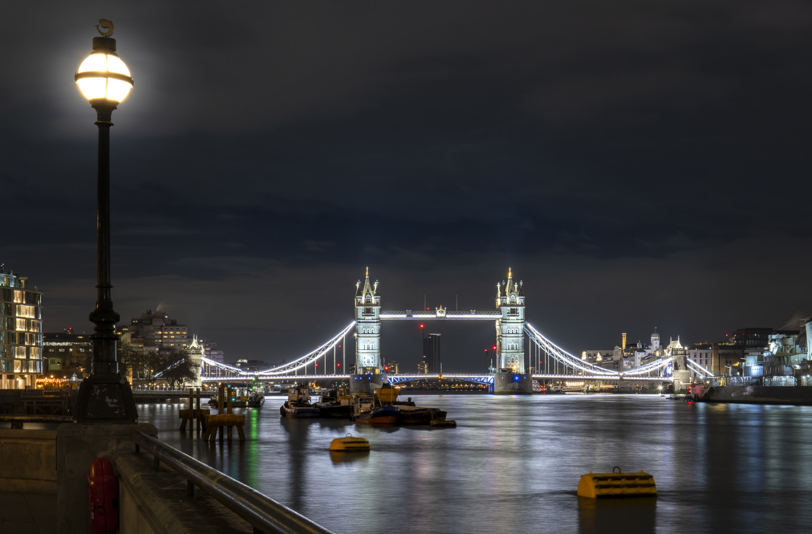 Tower Bridge and Thames River at night © Leo Hillier